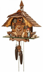One Day cuckoo clock chalet with lady ringing bell, hand-carved trees, dog, and bunny