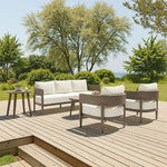 Outdoor patio furniture set on a wooden deck with trees and grass in the background