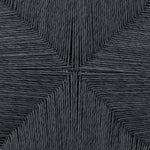 Close-up of textured black fabric with a geometric pattern