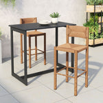 Outdoor setting with a black dining table and two wooden chairs on a tiled patio.