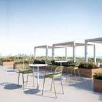 Outdoor rooftop patio with tables and chairs on a clear day