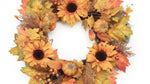 Faux fall wreath with autumn leaves and pumpkins