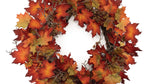 Autumn leaf wreath with red, orange, and yellow leaves on a white background