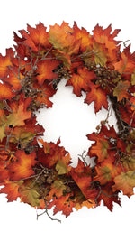 Autumn leaf wreath with red, orange, and yellow leaves on a white background