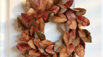 Autumn leaf wreath on a white door