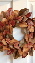 Autumn leaf wreath on a white door