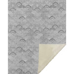 Gray patterned fabric with a corner showing a different texture