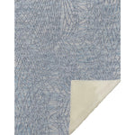 Textured blue rug with geometric pattern on a white background