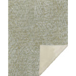 Textured green and beige rug with a corner showing a lighter color.