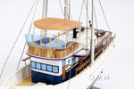 Yacht with wooden deck and blue hull on a white background