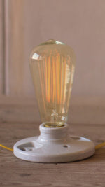 Transparent glass Edison bulb with filament for accent lighting in cafes