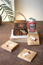 Wooden coasters with Colson's beer branding on a wooden surface.