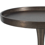 Close-up of a dark metal side table on a white background