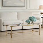 Living room with a gold coffee table, white sofa, and decorative elements.