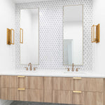 Bathroom vanity with wooden cabinets, white countertop, and gold fixtures.