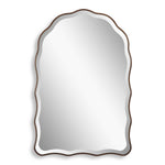 Decorative mirror with wavy edge and bronze frame on a white background