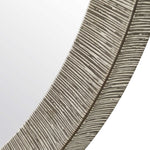 Close-up of a feather with detailed texture on a light gray background