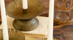 Decorative candle holders with candles on a wooden surface
