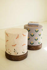 Cream upholstered ottoman with embroidered detail
