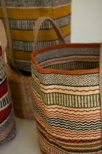 Woven baskets with striped patterns on a white surface