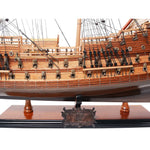 Wooden model ship on a stand with intricate details