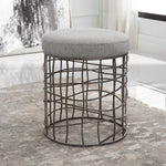 Modern round upholstered stool with iron base by Uttermost
