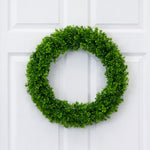 Green wreath on a white door