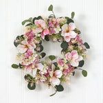 Floral wreath with pink and white flowers on a white wooden background