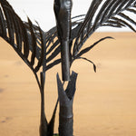 Black artificial palm tree for spooky Halloween home décor.