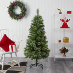 Decorated room with a Christmas tree, wreath, and festive decor.