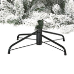 Black metal Christmas tree stand with a small tree on a white background