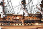 Detailed model of a ship with multiple masts and rigging on a white background