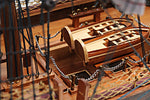Wooden model ship with intricate details on a wooden surface