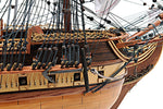 Close-up of a wooden ship model with intricate details