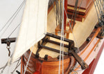 Close-up of a wooden model ship with detailed rigging and woodwork.