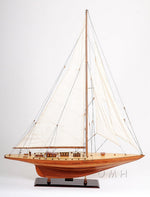 Wooden sailboat model on a white background