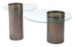 Two cylindrical glass top tables with bronze metal bases on a white background
