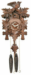 Wooden cuckoo clock with floral designs and bird figures on a white background
