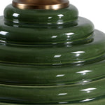 Close-up of a green ceramic object with a reflective surface