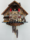 Wooden cuckoo clock with detailed design on a white background