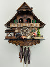 Wooden cuckoo clock with detailed design on a white background