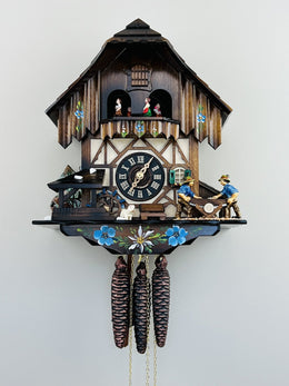 Wooden cuckoo clock with detailed design on a white background