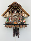 Wooden cuckoo clock with detailed design on a white background