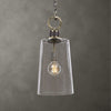 Clear glass pendant light with visible bulb against a gray background