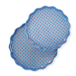 Two blue ceramic plates with red floral patterns on a white background