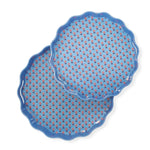 Two blue ceramic plates with red floral patterns on a white background