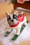 Ceramic Christmas skiing dog figurine with painted details and glossy glazed finish