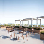 Outdoor rooftop patio with tables and chairs on a clear day
