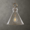 Pendant light with clear glass shade and brass fixture on a gray background
