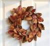 Autumn leaf wreath on a white door